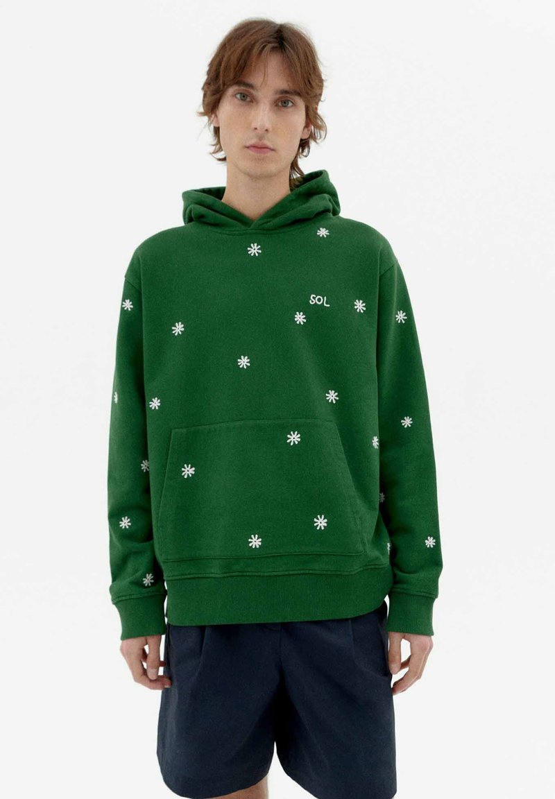 Green hoodie made of cotton, featuring white flower patterns, a front pocket, and a drawstring hood, with "SOL" logo on the chest.