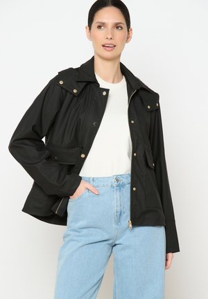 Black jacket with a zip closure, snap buttons, and front pockets. Made from smooth, lightweight fabric; features a classic collar and relaxed fit.