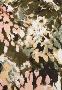 Motif floral abstrait sur tissu avec des taches et formes vert foncé, rose pâle, beige, blanc et noir.