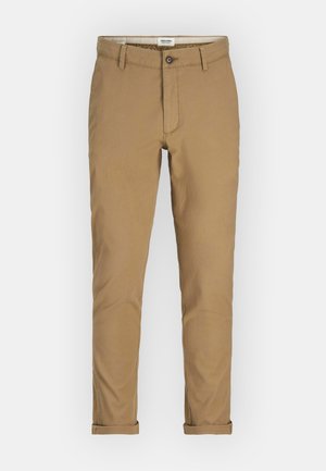 Pantalons chino dans une teinte marron clair, dotés d'une fermeture à bouton, de poches latérales et de ourlets roulés. Fabriqués en tissu coton léger.