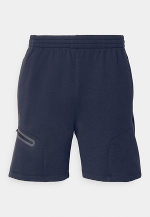 Shorts de sport bleu marine en tissu doux. Dotés d'une taille élastique et d'une poche zippée avec des accents gris sur les côtés.