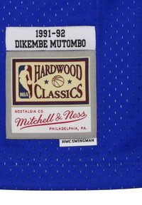 Blue mesh basketball jersey featuring a sewn tag with "1991-92," "DIKEMBE MUTOMBO," and "HARDWOOD CLASSICS" logos, with white and red accents.