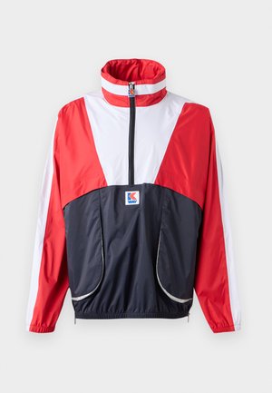Red, white, and navy windbreaker jacket with high collar, zip closure, and elastic waistband. Features two front pockets and contrasting colors.