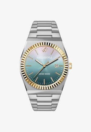 Reloj de pulsera plateado con caja hexagonal, esfera en degradado de teal a rosa, bisel con acentos dorados y display de fecha a las 3 en punto. Fabricado en Suiza.