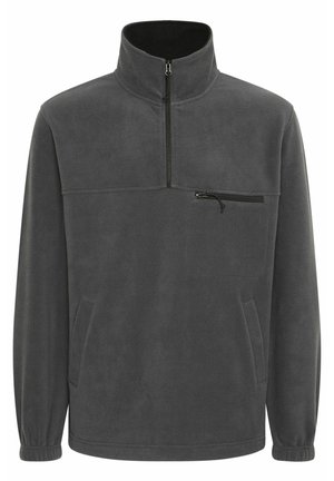 Gray fleece pullover with a high collar, half-zip closure, front chest pocket, and side pockets; soft texture and elastic cuffs.