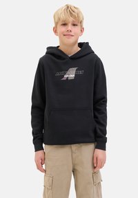 Haut à capuche noir avec une poche avant et un cordon de serrage. Présente un imprimé logo argenté sur la poitrine. Matière douce avec une coupe décontractée.