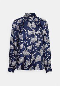 Blusa di seta blu navy con motivo floreale bianco, chiusura con bottoni e maniche lunghe. Texture liscia con colletto a punta e dettagli ai polsini.