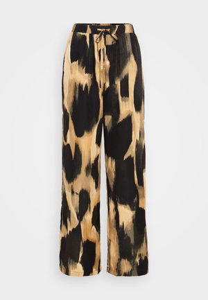 Pantalon ample avec motif tie-dye abstrait noir et beige, taille élastique et cordon à l'avant.