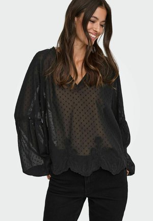 Blusa nera trasparente con scollatura a V, motivo a pois e orlo inferiore ricamato con fiori. Presenta maniche voluminose e una finitura texturizzata.