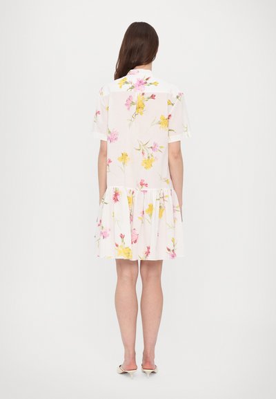 Short-sleeve, white dress with a floral pattern in pink and yellow. Features a tiered ruffle at the hem and a collar.