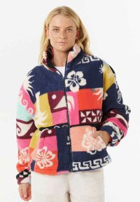 Veste en polaire avec un design en patchwork aux couleurs vives, présentant des motifs floraux, un col montant et des poches frontales, avec une fermeture éclair.