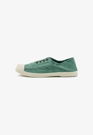 Green canvas slip-on shoe with a textured surface, rubber toe cap, and small metal eyelets. Features a contrasting white sole.