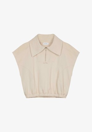 Beige cropped top with a large collar, short sleeves, and a front zipper. Features a gathered hem and subtle texture. Brand label inside.