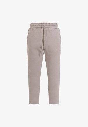 Pantalons de survêtement gris clair en tissu doux, dotés d'une taille élastique avec cordon de serrage, de poches latérales et de chevilles fuselées.