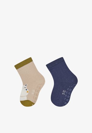 Children's socks: one beige with a snowman and olive green ribbed cuff; one navy blue with a ribbed texture. Both have non-slip grips.