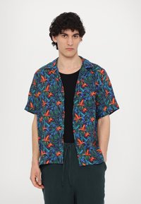 Short-sleeve shirt with a dark background featuring a floral print in orange, blue, and green. Soft fabric, button-up design, casual fit.