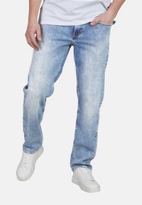 Jeans in denim chiaro con vestibilità dritta, caratterizzati da un classico design a cinque tasche e un leggero scolorimento sulle cosce.