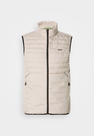 Light beige padded sleeveless vest with black zipper, high collar, two zippered side pockets, and "BOSS" logo on the chest.