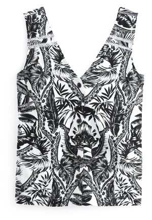 Haut sans manches noir et blanc avec boutons, col en V et motif tropical de feuilles et fleurs.