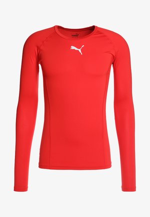 Punane pikaaheline spordisärk, mis on valmistatud siledast ja venivast materjalist. Sellel on valge logo rinnal ja see on väljatoodud disainiga.