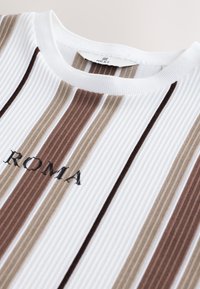 Ribbed knit t-shirt featuring vertical stripes in white, beige, brown, and dark brown with embroidered "ROMA" in black on front.
