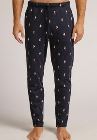 Pantalones de pijama azul marino hechos de una tela suave, con un patrón de pequeñas figuras de estilo caricaturesco. Cintura elástica con detalle de cordón.