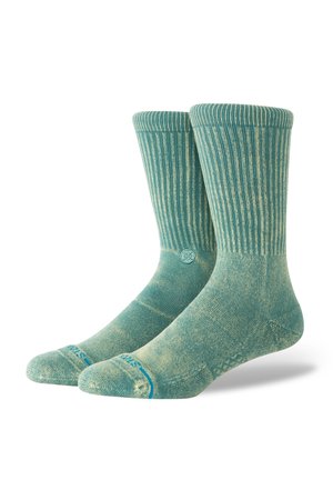 Heledad rohekas-sinised sokid soonikmustriga, tugevdatud varvaste ja kandadega. Kaunid peened mustrid ja logo pahkluulähedal.