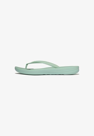 Light green flip-flop sandal with textured strap and cushioned sole shown in side profile on white background.