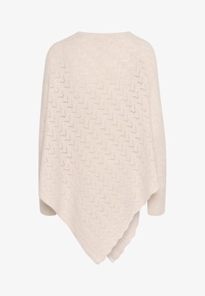 Krém színű kötött poncsó cikk-cakkos áttört mintával és bordázott mandzsettákkal, aszimmetrikus szegéllyel.