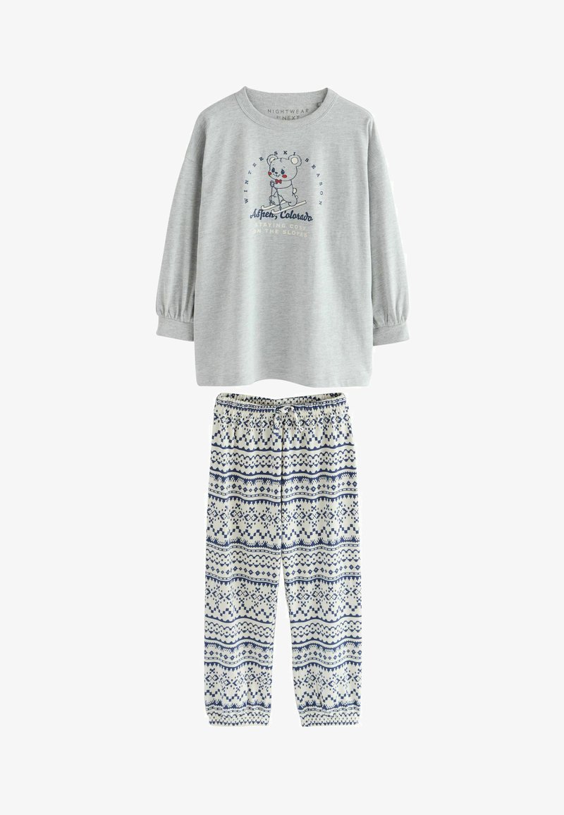 Haut à manches longues gris avec un graphisme d'ours et du texte. Pantalon blanc avec des motifs géométriques bleus et une taille élastique. Tissu doux, coupe décontractée.