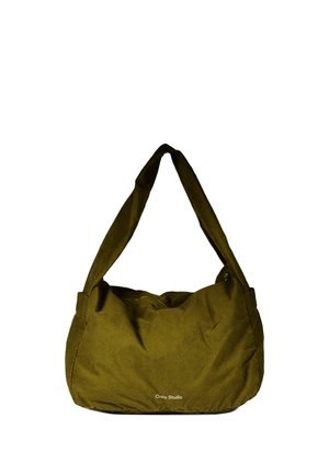 Sac d'épaule en tissu vert olive avec une large bandoulière et un petit logo blanc "Craie Studio" à l'avant.