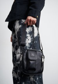 ESSENTIALS BAG UNISEX - Cross body bag - black