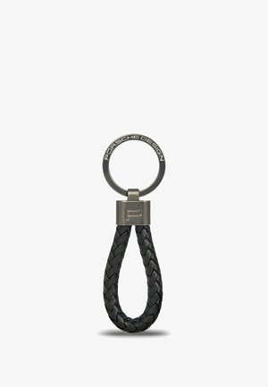 Keyring with braided black leather loop, metal top piece engraved with "Porsche Design," and circular metal ring with engraved logo.