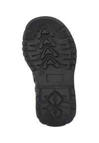 Suela de zapato de goma negra con un patrón texturizado, que presenta surcos en zigzag y acentos en forma de diamante para ofrecer tracción y estabilidad.