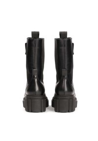 Black leather ankle boots with a chunky textured sole, vertical seam details, and pull tabs at the back for easy wear.