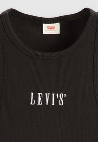 Mustat ribbed hihattomat topit, joissa on valkoinen Levi's-logo brodeerattuna rinnassa ja Levi's-kokolappu sisäkauluksessa.