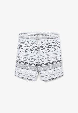 Weiße Shorts mit schwarzen geometrischen Diamant- und Streifenmustern, ausgestattet mit einem elastischen Bund und einer vorderen Kordel.