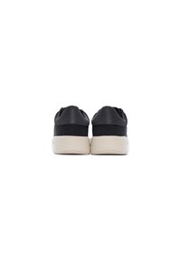 Sneakers neri con una finitura liscia, suole in gomma e un design a profilo basso. Presentano un logo discreto sul tallone e supporto per la caviglia imbottito.
