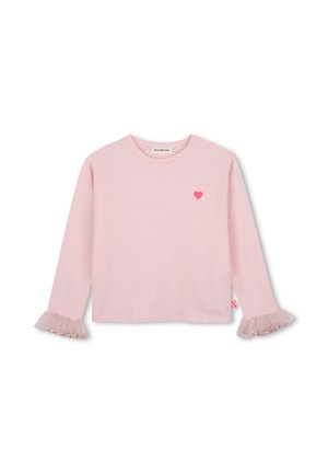 Lichtroze shirt met lange mouwen met een klein rood hartje op de borst en gerimpelde manchetten versierd met kleine kleurrijke kralen.