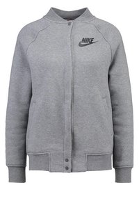 Felpa grigia Nike con colletto rotondo, maniche a cuffia, chiusure a scatto, tasche laterali e logo nero sul petto. Tessuto morbido e strutturato.