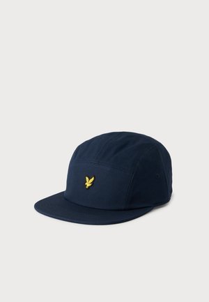Marineblå fempanel cap med flad skygge og lille gul broderet fuglelogo centreret på frontpanelet.