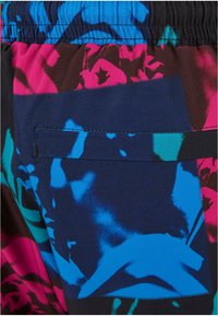 Swim trunks in a multicolor graphic design with black, blue, pink, and teal. Features an elastic waistband and a single back pocket.