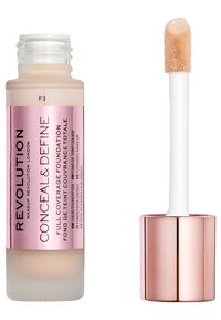 Fond de teint à couvrance complète dans un flacon en verre givré avec une étiquette rose, doté d'un applicateur blanc et d'un capuchon métallique rose gold.