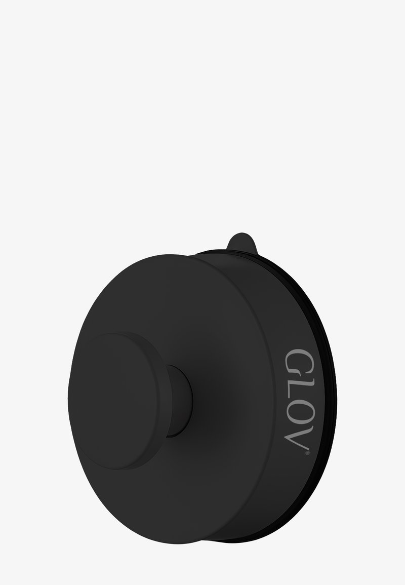 Svart, sirkulær kosmetisk applikator med en jevn overflate og en fremtredende sentral knapp. Merkenavnet "GLOV" er preget på siden.