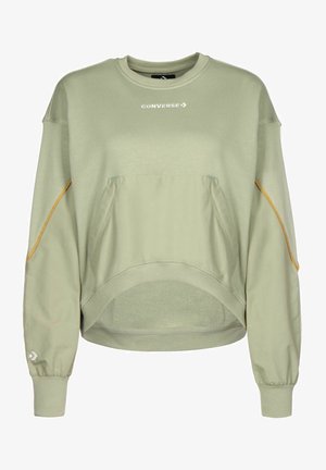 Sudadera de color verde claro con un corte cuadrado, puños acanalados y un gran bolsillo frontal. Presenta un logo sutil y detalles en naranja contrastante.