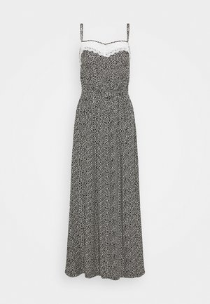 Schwarz-weißes Maxikleid mit dünnen Trägern, einer Spitzeneinfassung am Ausschnitt und einem gepunkteten Muster. Elastischer Bund für eine optimale Passform.