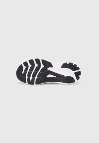 Black and white athletic shoe sole with textured rubber for traction, featuring a wavy design and grooves for flexible movement.