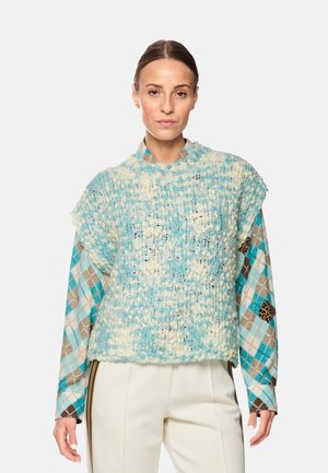Knitted pullover in light blue and cream, featuring a textured design. Long sleeves display a checkered pattern in blue, brown, and tan.