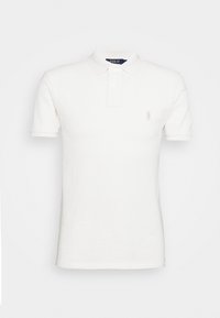 White polo shirt made of cotton, featuring a buttoned collar, short sleeves, and a small embroidered logo on the left chest.