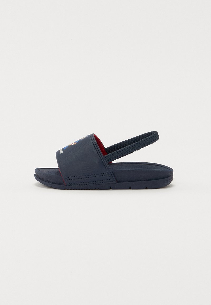Navy blue sandals with a textured strap and rubber sole. Features an open toe, back strap, and red inner lining.